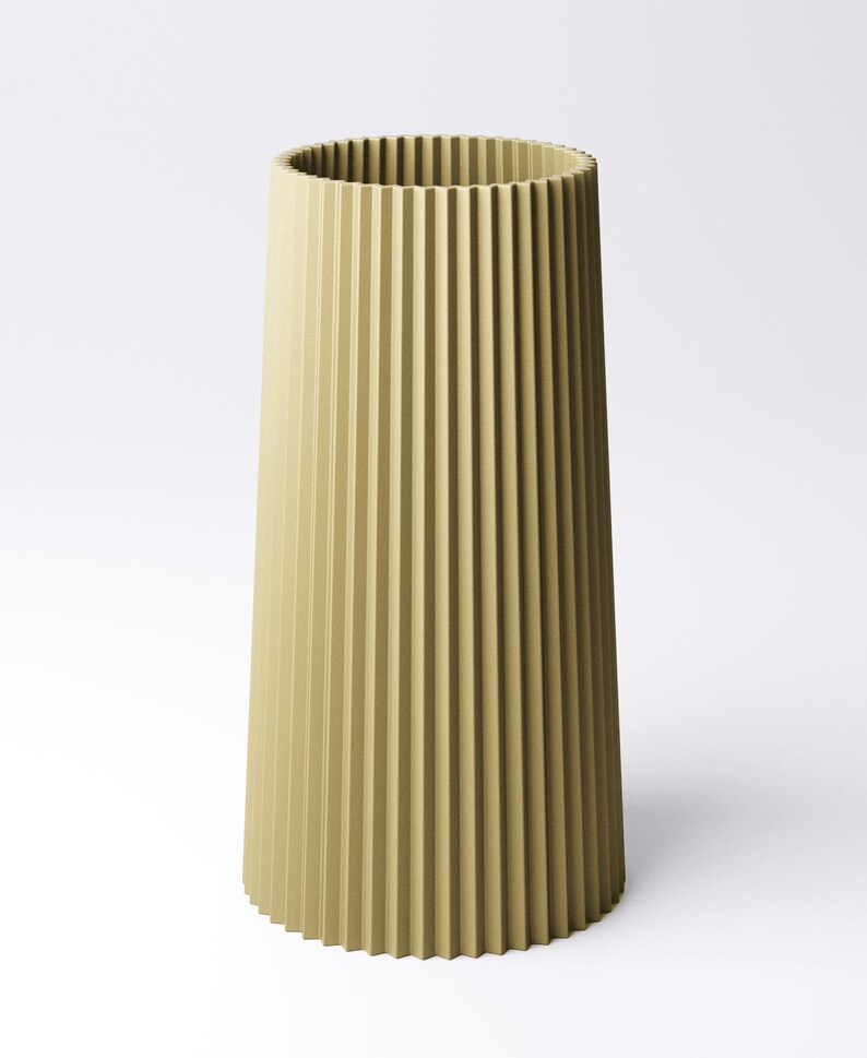 May include: A tall, olive-green vase with a ribbed, vertical design. The vase has a cylindrical shape with a slightly flared base and a wide opening at the top. The ribbed texture adds visual interest to the minimalist design.