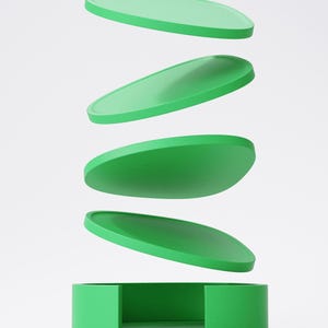May include: A green box with four oval lids, appearing to float above it. The lids are stacked, suggesting motion. The design is simple and modern, with a focus on form and colour. The box and lids are a vibrant green.