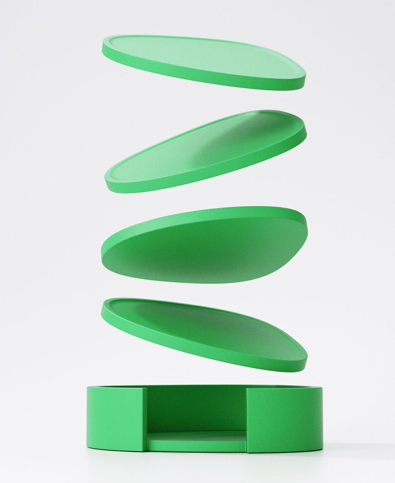 May include: A green box with four oval lids, appearing to float above it. The lids are stacked, suggesting motion. The design is simple and modern, with a focus on form and colour. The box and lids are a vibrant green.