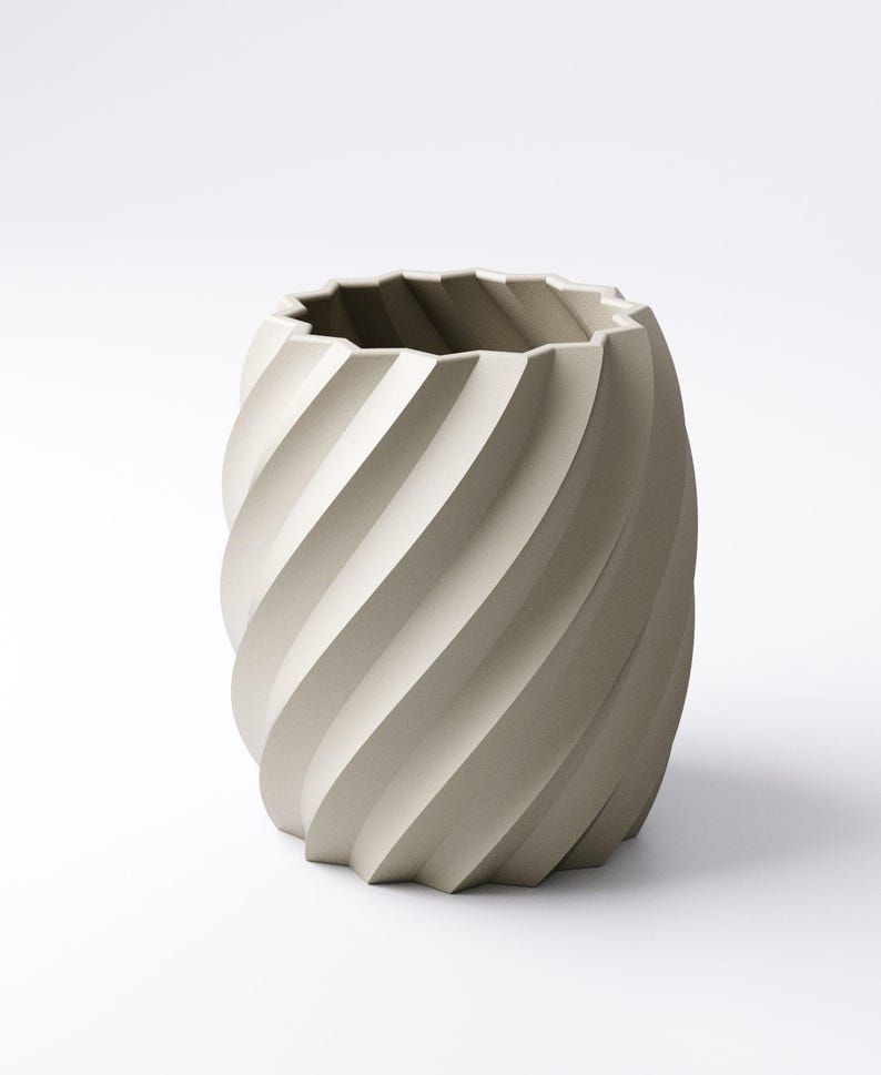 May include: A beige, cylindrical vase with a spiral design. The vase has a textured surface and a jagged top edge. The design features a series of diagonal, curved lines that wrap around the vase, creating a sense of movement.