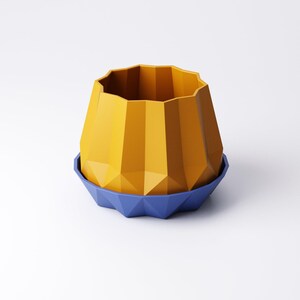 May include: A geometric, yellow planter with a faceted design, sitting on a blue, similarly designed saucer. The planter has a wide, open top and a textured surface. The design is modern and minimalist.