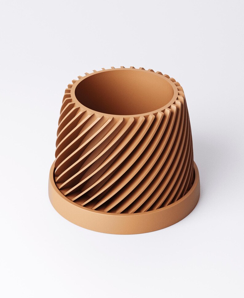 May include: A terracotta-colored planter with a unique spiral design. The planter has a cylindrical shape with vertical, curved ridges that create a textured surface. It sits on a matching saucer, suitable for indoor or outdoor use.