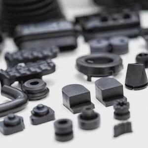 May include: An assortment of black rubber parts, including tubes, seals, and various shaped components. The collection features a variety of sizes and designs, suitable for industrial or mechanical applications. The parts are arranged on a white surface.