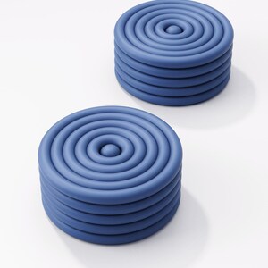 May include: Two blue, circular objects with a spiral design. Each object is made of stacked, concentric rings, creating a layered effect. The objects are on a white background.