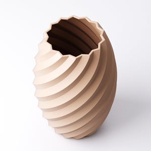 May include: A beige, spiral-shaped vase with a textured surface. The vase has a wide, scalloped opening and a rounded base. The design features horizontal, curved lines that create a sense of movement. The vase is a decorative item.