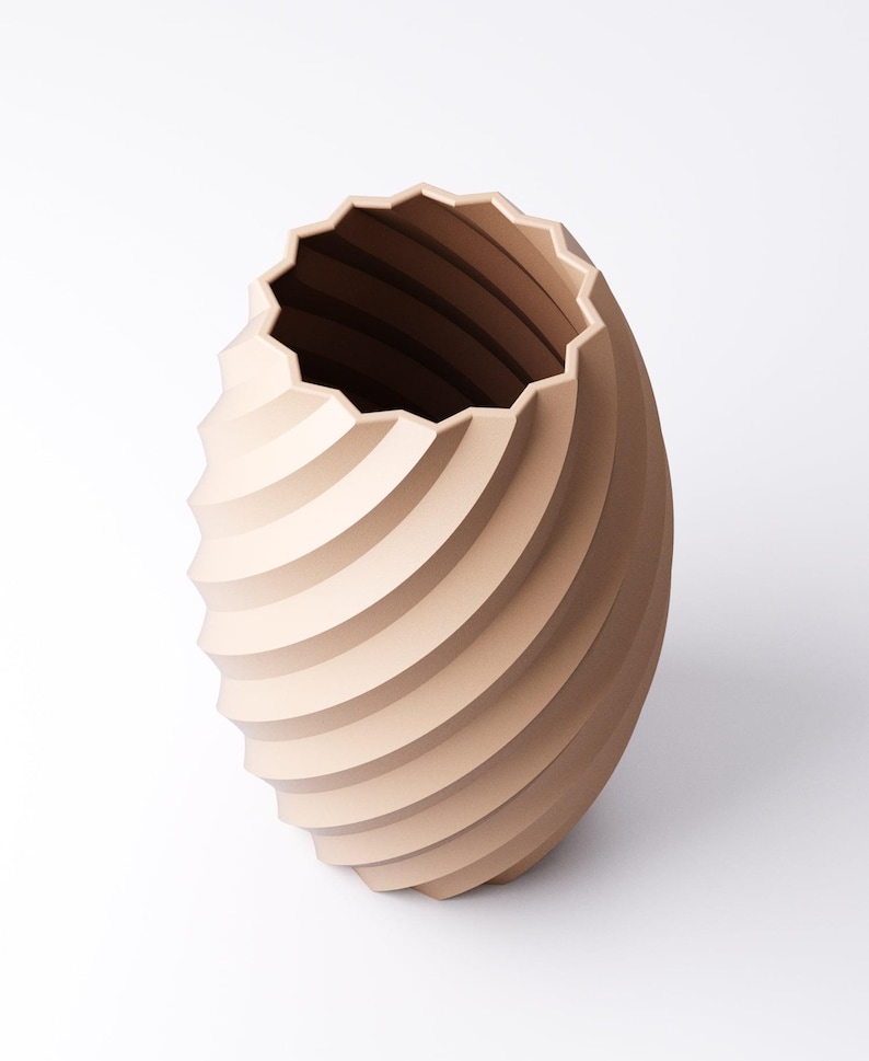 May include: A beige, spiral-shaped vase with a textured surface. The vase has a wide, scalloped opening and a rounded base. The design features horizontal, curved lines that create a sense of movement. The vase is a decorative item.