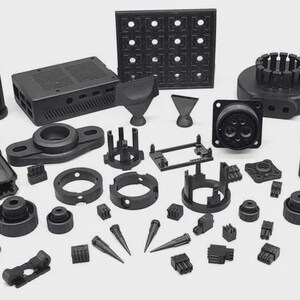 May include: An assortment of black plastic components, including connectors, housings, and various geometric shapes. The collection features circular, rectangular, and conical elements, suggesting a focus on industrial or electronic applications.