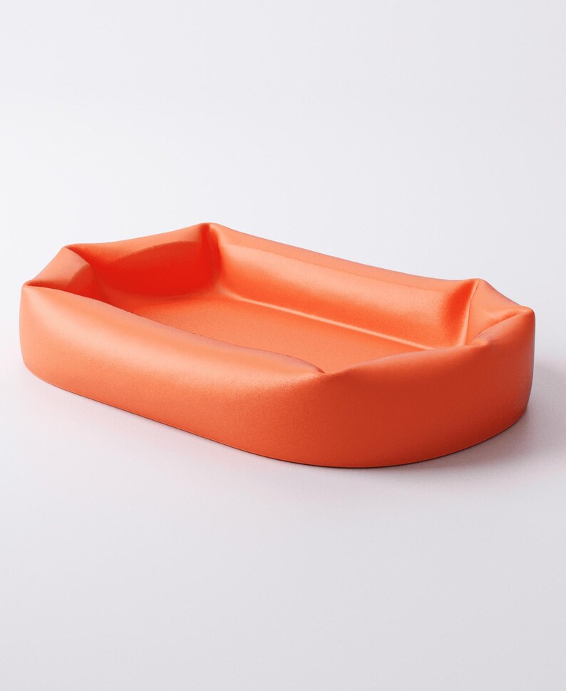 May include: An orange rectangular tray with rounded corners. The tray has a slightly raised edge and a smooth, matte finish. The product is designed to hold small items.