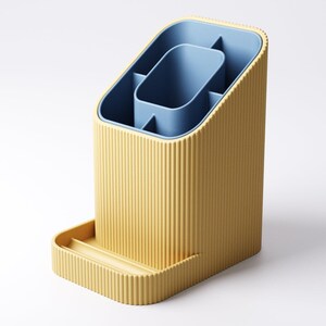 May include: A yellow and blue desk organizer with a ribbed exterior. The organizer has a rectangular base with a small tray and an angled top. The interior features a blue compartment with several sections for storage.