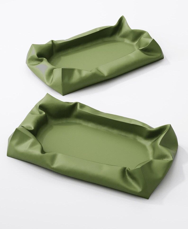 May include: Two olive green trays with a rectangular shape and a ruffled edge. The trays are empty and appear to be made of a smooth, possibly synthetic material. The background is white.