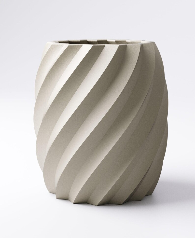 May include: A beige, cylindrical vase with a spiral design. The vase has a textured surface and a geometric base. The interior is dark, and the overall aesthetic is modern and minimalist. The vase is suitable for home decor.