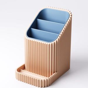 May include: A peach-colored desk organizer with a blue interior and three compartments. The organizer has a rectangular base with a small tray and a ridged exterior design. The interior is a light blue color.