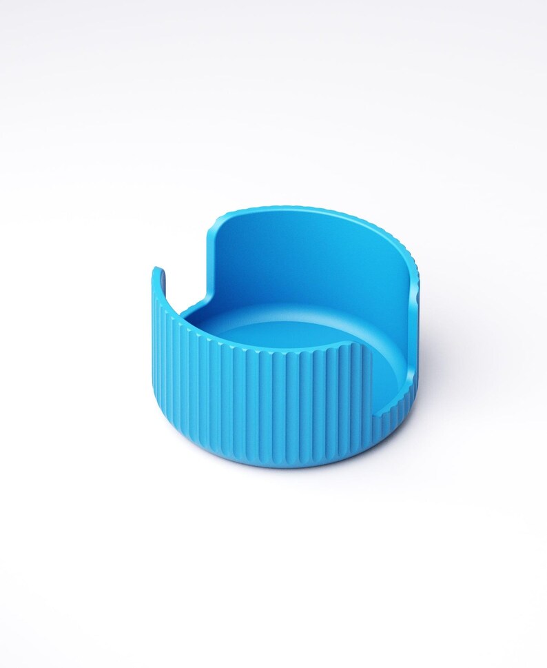 May include: A bright blue, semi-circular container with a ridged exterior and a smooth interior. The container has a curved back and two small, vertical extensions on either side. The object is set against a white background.