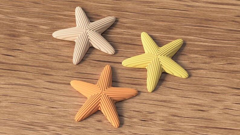 May include: Three starfish in shades of cream, yellow, and orange rest on a wooden surface. Each starfish has a textured, ridged design. The starfish are arranged in a triangular pattern.