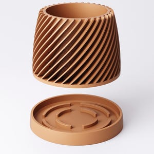 May include: A terracotta-colored planter with a unique design. The cylindrical pot features a spiral pattern of vertical slats, and sits above a matching round base. The planter is designed for indoor or outdoor use.