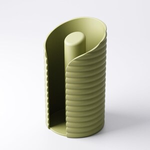 May include: A sage green paper towel holder with a cylindrical design. The holder features a central post and a curved, ridged exterior. The design is modern and minimalist, suitable for a kitchen or bathroom.