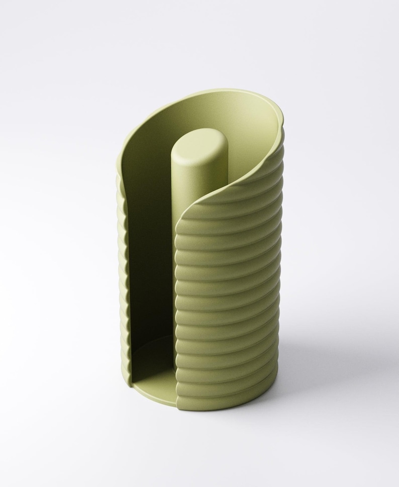 May include: A sage green paper towel holder with a cylindrical design. The holder features a central post and a curved, ridged exterior. The design is modern and minimalist, suitable for a kitchen or bathroom.