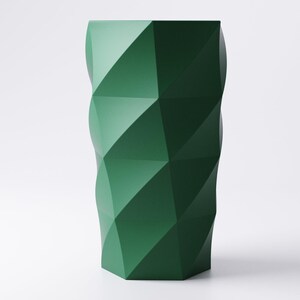 Op de afbeelding: Een hoge, geometrische vaas in een diepe bosgroene kleur. De vaas heeft een facetontwerp, met meerdere driehoekige en ruitvormige panelen die een textuur cre&euml;ren. De vaas is een modern decoratief item.