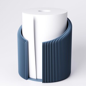 May include: A modern, blue toilet paper holder with a vertical ribbed design. The holder encases a white roll of toilet paper, with a portion of the paper extending out. The design is minimalist and contemporary, suitable for bathroom decor.