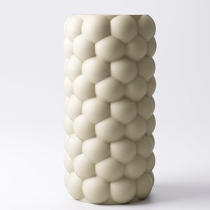 May include: A tall, off-white vase with a textured surface. The vase is cylindrical and covered in a pattern of rounded, interconnected shapes, resembling bubbles or cells. The design gives the vase a unique, modern aesthetic.