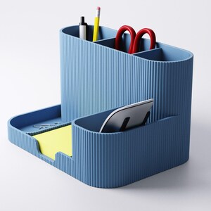 May include: A blue desk tidy with various compartments. It includes sections for pens, pencils, and scissors, a tray for sticky notes and a slot for a tablet. The organiser is made of a ribbed material.