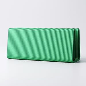 May include: A rectangular, bright green object with a ribbed texture. The object has a folded design, with rounded corners. The color is a vibrant, solid green, and the surface has vertical ridges. The object is set against a plain white background.
