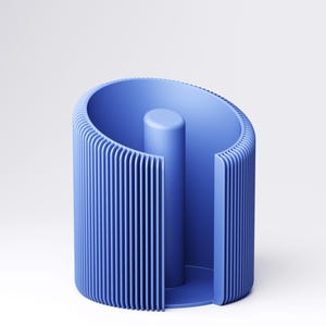 May include: A blue cylindrical object with vertical ribbed detailing. The design features a central, solid cylinder and a curved outer wall. The object is made of a solid, matte material and is set against a white background.