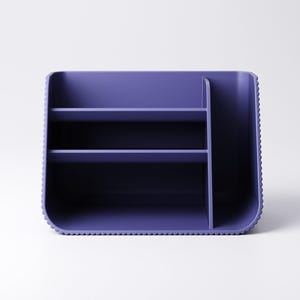 May include: A purple desk organizer with multiple compartments and shelves. The organizer has a rectangular shape with rounded corners and a textured edge. It is designed to hold various office supplies.