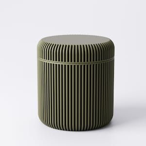 May include: A cylindrical container in a muted olive green hue. The container features a ridged, vertical design on its exterior, with a matching lid. The overall shape is rounded, and the design is minimalist and modern.