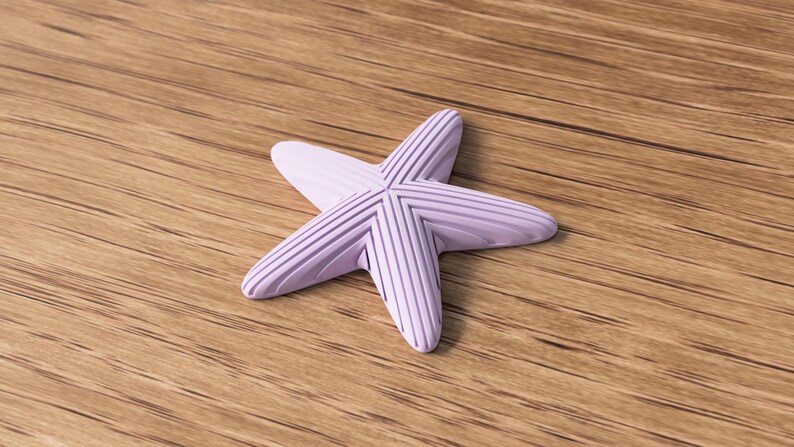 May include: A light purple starfish with textured, ridged arms. The starfish is centered on a wooden surface with visible wood grain. The starfish is a decorative item, possibly for coastal or nautical themed decor.