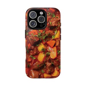 May include: A phone case featuring a vibrant image of a hearty stew. The design showcases chunks of beef, potatoes, carrots, and fresh herbs in a rich, red sauce. The case has a glossy finish and a black camera module.