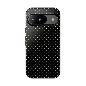 May include: Black phone case with a white polka dot pattern.