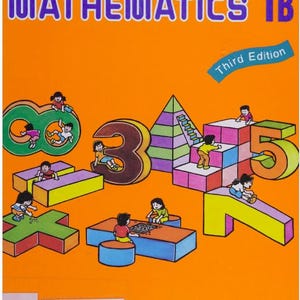 May include: An orange textbook cover with the title "PRIMARY MATHEMATICS 1B" in blue and white. The cover features colorful illustrations of children playing on large numbers and shapes. The words "Third Edition" are also visible.