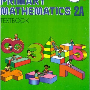 May include: A textbook cover for "Primary Mathematics 2A" with a green background. The cover features large, colorful numbers 8, 3, and 5, with children interacting with them. The text "U.S. EDITION" is in a red banner.