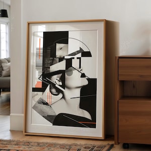 Puede incluir: Una impresión de arte abstracto en blanco y negro que presenta el rostro de una mujer con formas geométricas y líneas. La impresión está enmarcada en un marco de madera claro.