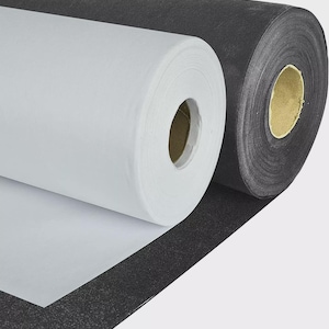 May include: Two rolls of paper are shown, one white and one black. The white roll is partially unrolled, showing the paper's texture. The black roll is behind the white one. These rolls are likely for crafts or art projects, possibly for wrapping.