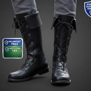 May include: Black leather knee-high boots with lace-up detailing and a fold-over cuff. The boots have a sturdy sole and are shown from the knees down. The boots are displayed against a dark background.