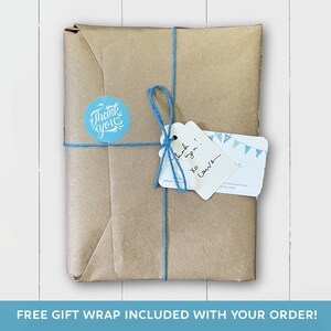 May include: A brown paper package tied with blue twine and a white gift tag. The tag has handwritten text that says "Thank you! xo Love". A round sticker with the text "Thank you" is on the package.