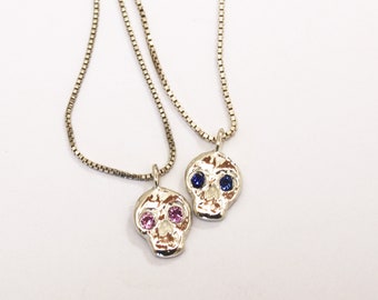 Skull friend charm with sapphire eyes