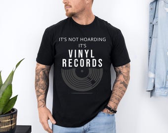 May include: A black t-shirt with white text that reads "It's not hoarding it's vinyl records". The shirt features a graphic of a vinyl record.
