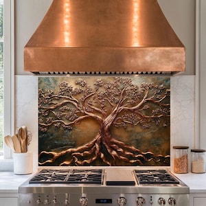 May include: A copper range hood with a decorative backsplash featuring a 3D embossed tree with gold and brown tones.