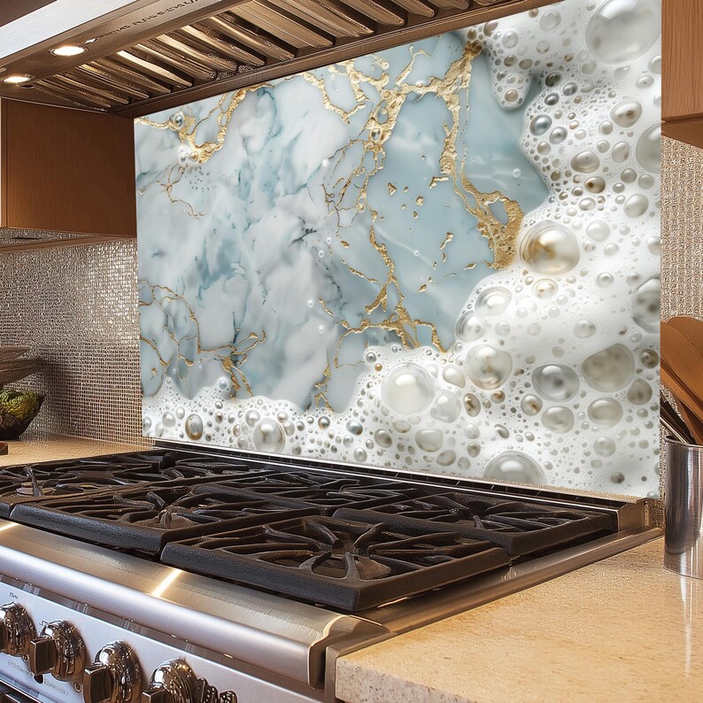 May include: A kitchen backsplash with a marble design featuring white and blue swirls with gold accents. The bottom of the backsplash has a white foam design with large and small bubbles.