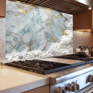 May include: A kitchen backsplash with a marble design featuring white, blue, and gold accents. The marble is topped with a layer of white foam with large bubbles.