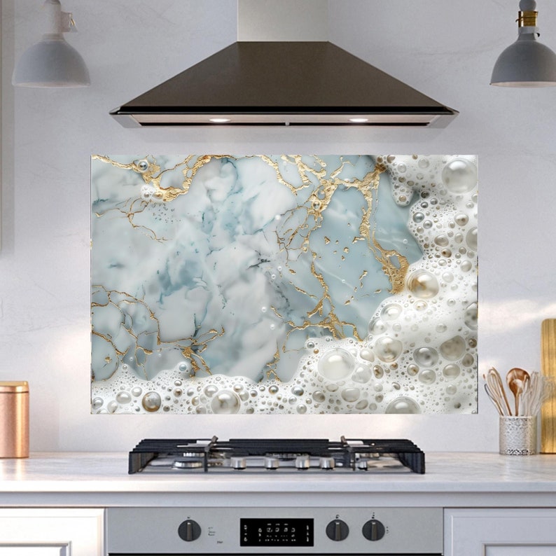 May include: A kitchen backsplash with a marble design featuring white and blue swirls with gold accents. The marble design is topped with a layer of white foam with large, round bubbles.
