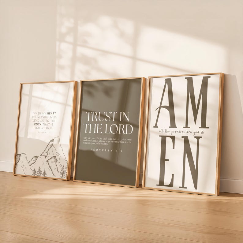 May include: Three framed art prints with inspirational quotes. The first print has a mountain illustration and text. The second print says "Trust in the Lord." The third print says "Amen." All prints have a wooden frame.
