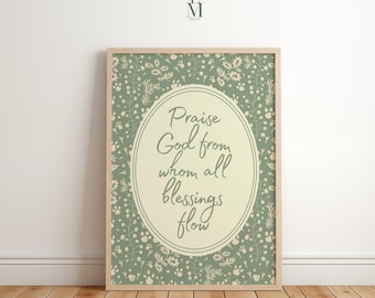 May include: Framed print with the text "Praise God from whom all blessings flow" in an oval shape. The background is a floral pattern in shades of green and cream. The frame is a light wood color.