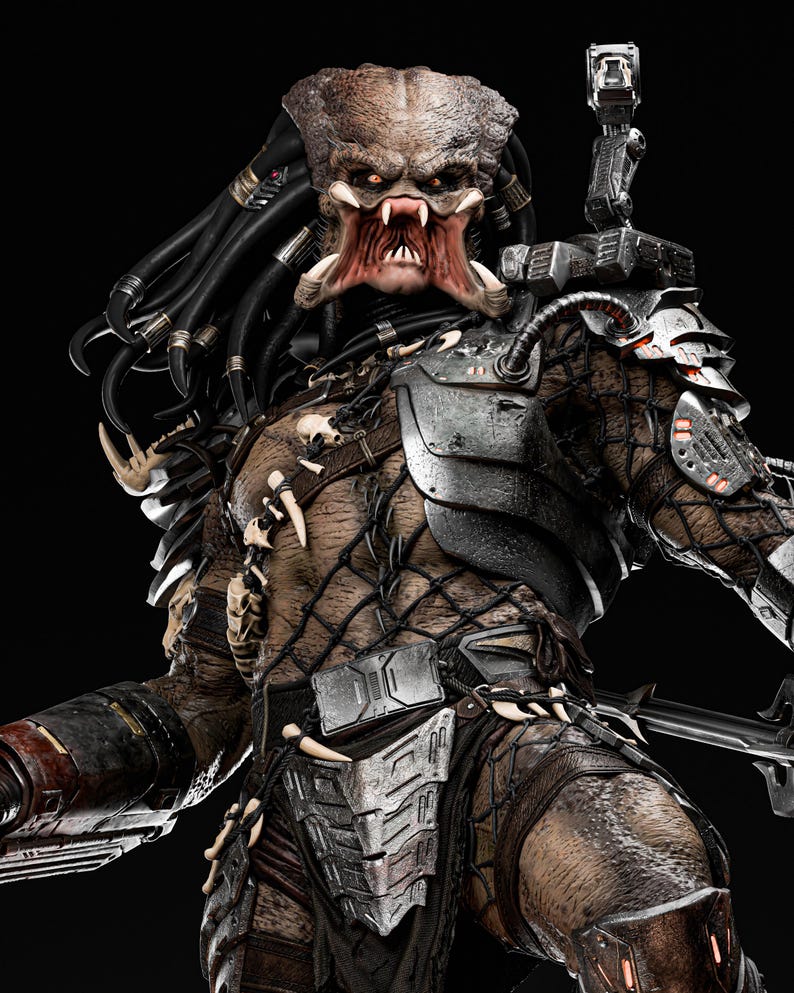 May include: A detailed, close-up of a Predator figure, showcasing intricate armor and a menacing facial expression. The figure features a brown and tan color scheme with metallic accents, sharp teeth, and dreadlocks. The background is black.