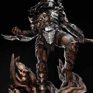 May include: A detailed Predator figure, standing on a tree-like base with skulls. The figure is clad in metallic armor and carries a bladed weapon. The figure has a masked head and dreadlocks, with a dark background.