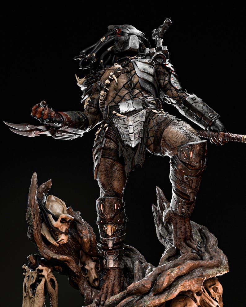 May include: A detailed Predator figure, standing on a tree-like base with skulls. The figure is clad in metallic armor and carries a bladed weapon. The figure has a masked head and dreadlocks, with a dark background.