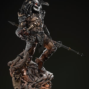 May include: A detailed statue of a Predator alien warrior, standing on a textured, organic base. The figure is clad in intricate armor with a mask, and holds a spear. The color palette includes shades of brown, black, and silver.
